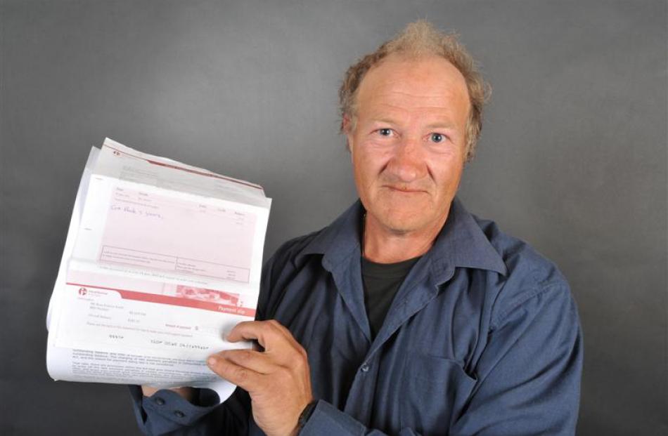 Ross Smith holds Inland Revenue Department statements with ''extortionate'' child support...