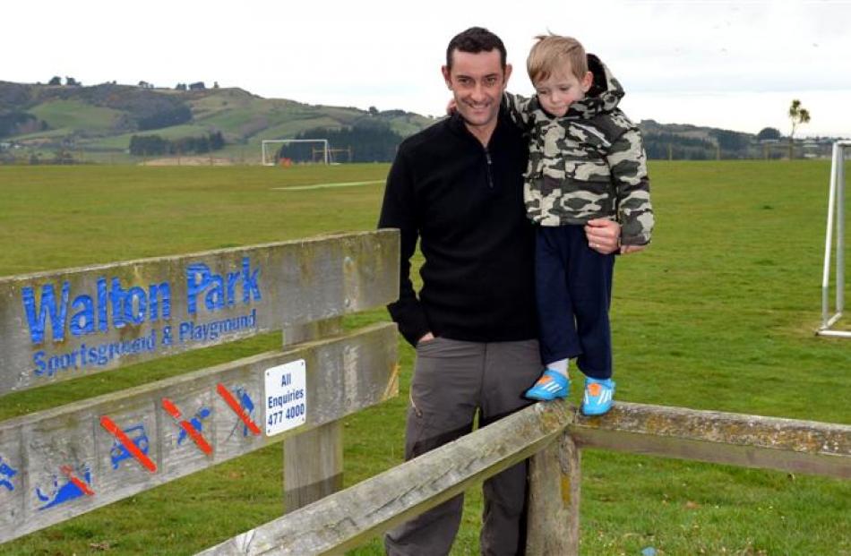 Saddle Hill Community Board chairman Scott Weatherall with son George (2) at Walton Park ain...