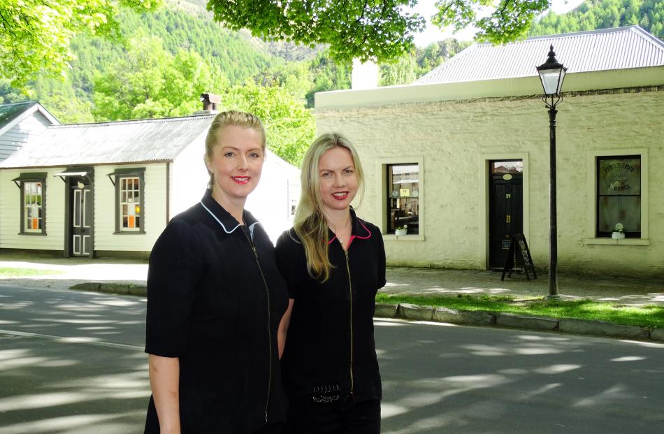 Sam Gent (left) and Amy Bennetts outside the  historic cottages in Buckingham St, Arrowtown....