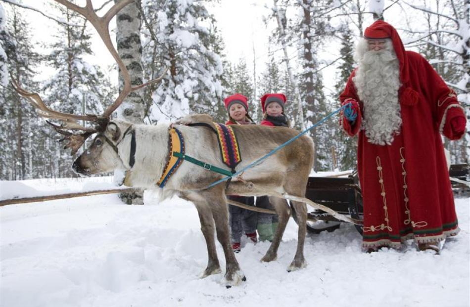 Santa and his reindeer and young helpers make a vivid impression at their village in northern...