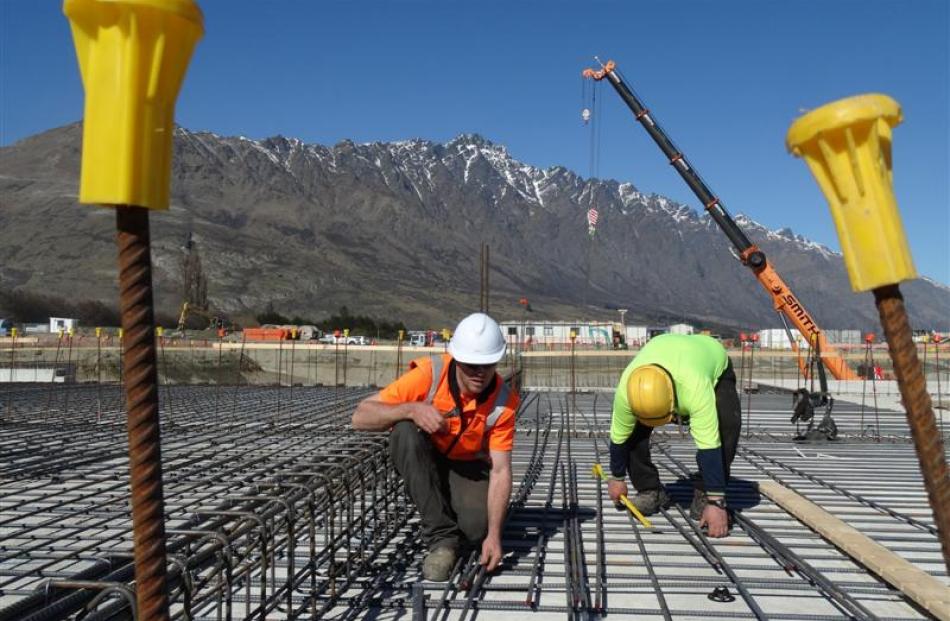 Scott Merrilees (left) and Chris Fleming, of building firm Naylor Love, work at the Five Mile...