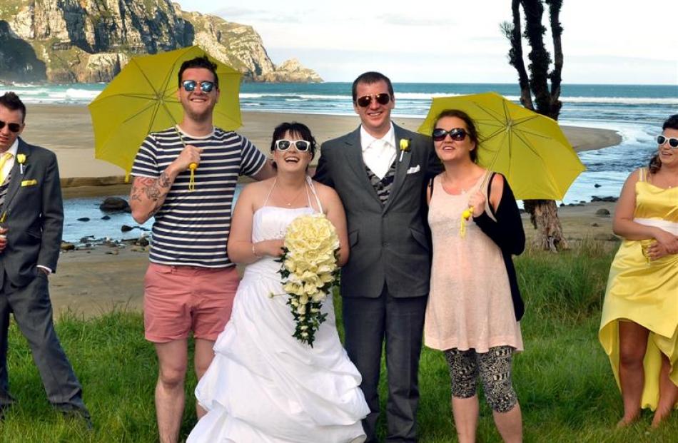Scottish tourists Connor Robertson (2nd left) and Karen McFarlane (2nd right) pose with newlyweds...