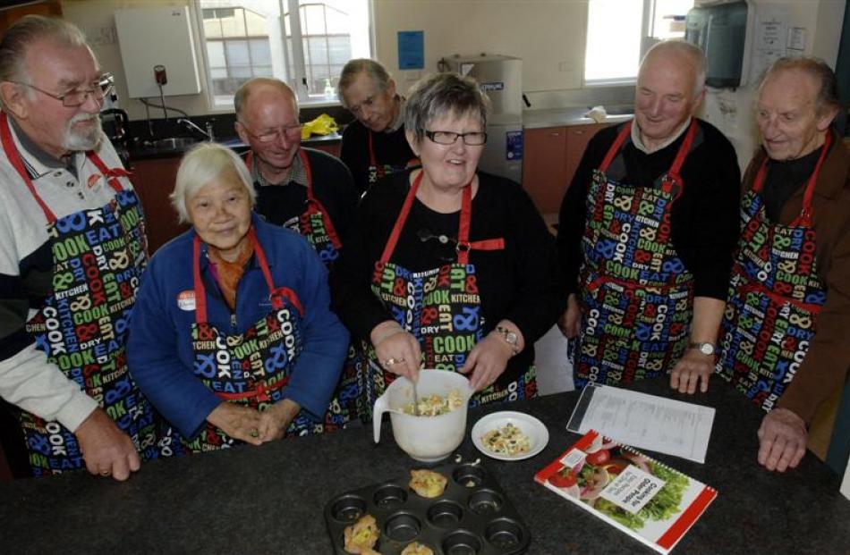 Senior chef tutor Lois Mitchell (centre) demonstrates food preparation techniques to (from left)...