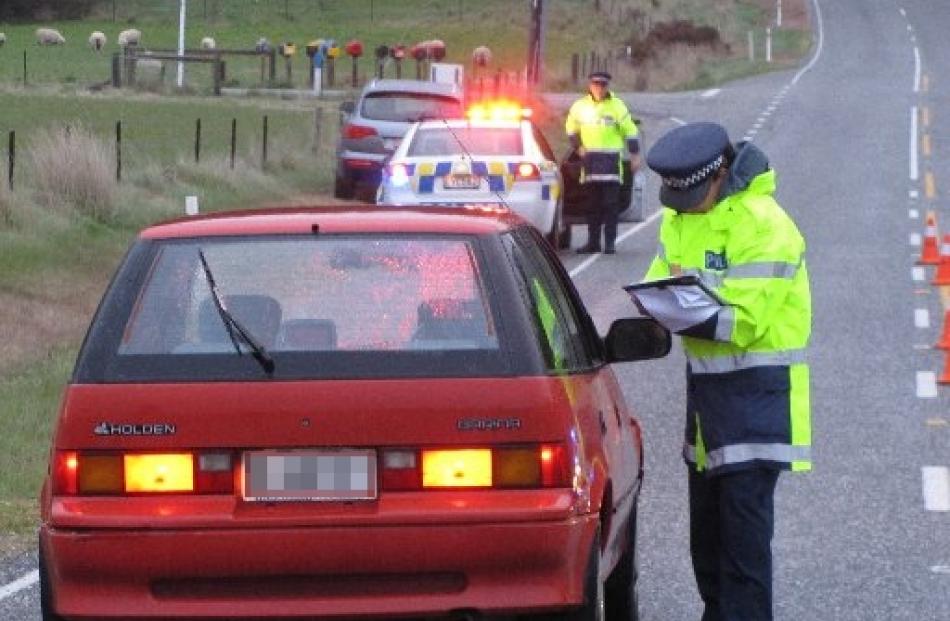 Senior Constable Emma Fleming speaks to a motorist early this morning as part of a police canvas...