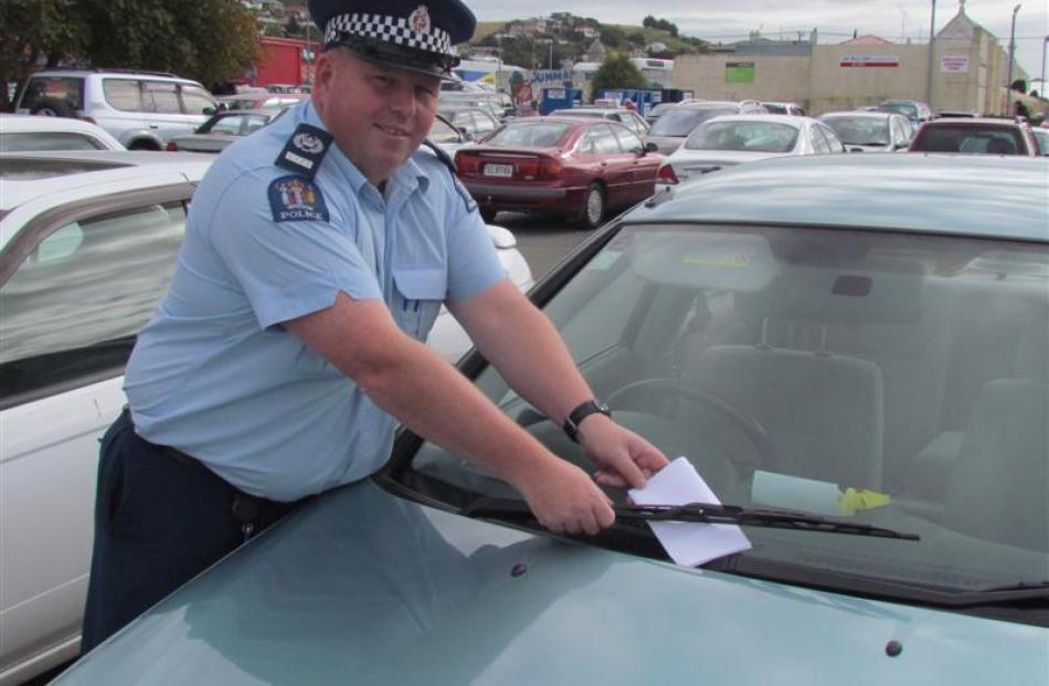 Senior Sergeant Jason McCoy, of Oamaru,  warns another motorist about the need to lock cars....