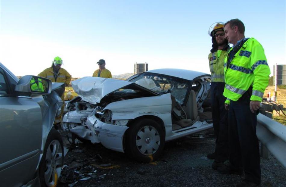 Sergeant Bruce Martin (left), of Alexandra, and Luggate firefighter Scott Challis discuss the...