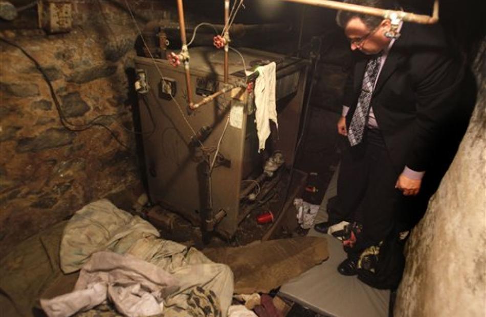 Sergeant Joseph Green stands in the Philadelphia basement where four malnourished, mentally...