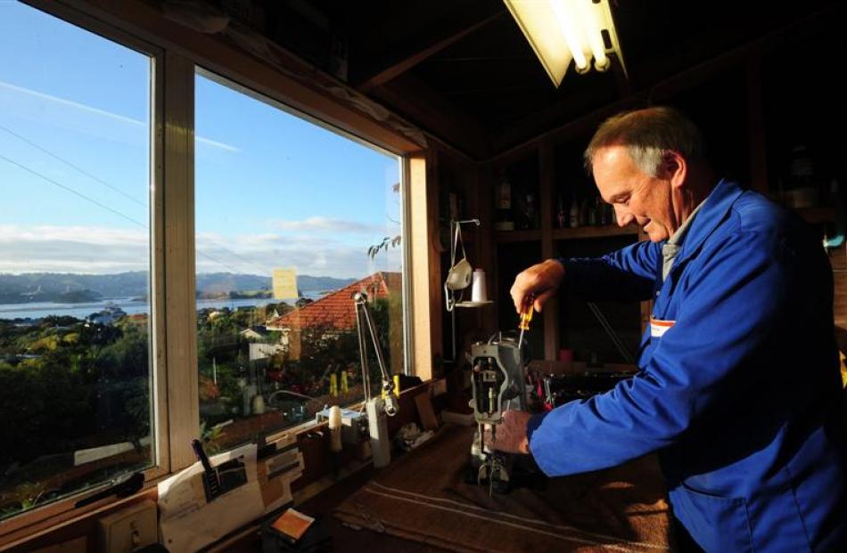 Sewing machine mechanic Murray McDowell at work in his Broad Bay workshop. Photo by Craig Baxter.