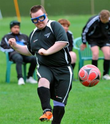 Shaun Crabtree, of Hawkes Bay, flicking a deft pass during a football match at the University Oval.