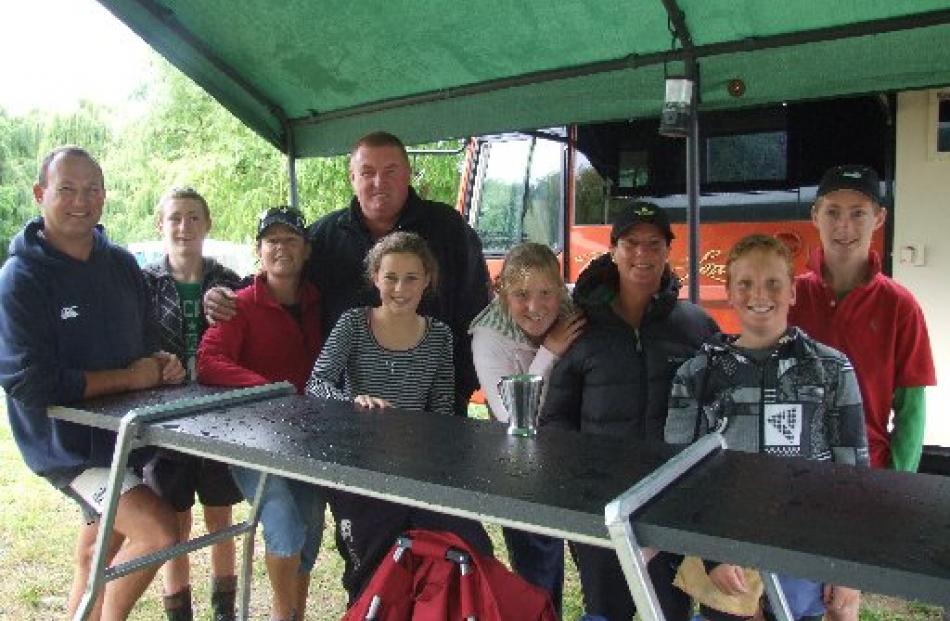 Sheltering at Waitangi yesterday are Michael Richardson, Lewey Richardson (14), Rebecca...