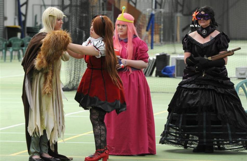Shinrii Sato, of Christchurch, adjusts the outfit of Natasha Bantuel, of Napier, as Emma...