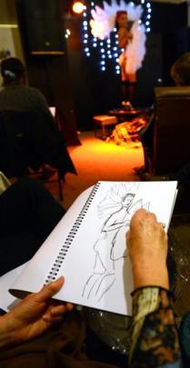 Shirley Symmott sketches while Cheviace Stylet poses in the background at Dr Sketchy's Anti-Art...