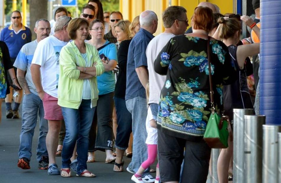 Shoppers queue outside Briscoes Homewares, in Dunedin. Photo by Stephen Jaquiery