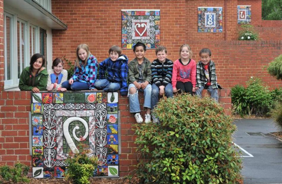 Showing off the new mosaic murals at Bradford School yesterday are (from left) Reyana Barringer...