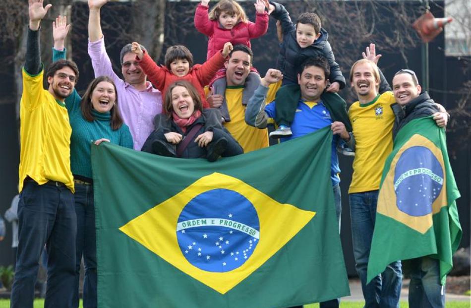 Showing their colours in Dunedin yesterday are Brazilian football fans (from left) Marcelo Castro...