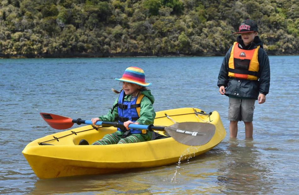 Siblings Efa and Sef Johnston play on the Taieri River after a day spent adventuring in its lower...