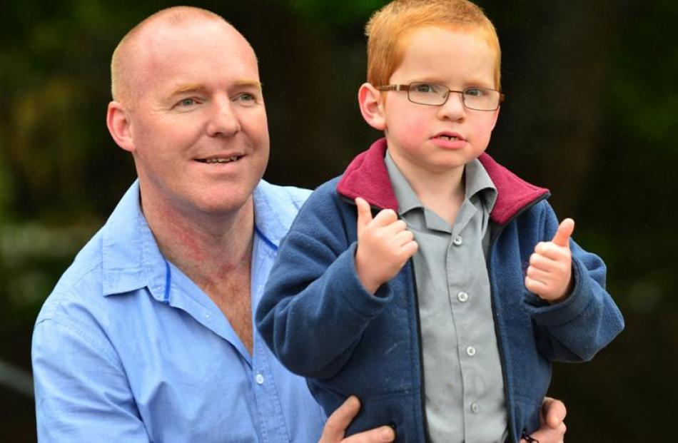 Sinclair May, with father Jason, gives the thumbs up yesterday. Photo by Peter McIntosh.