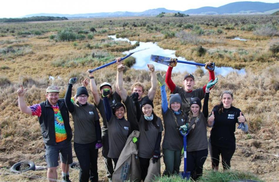 Sinclair Wetlands co-ordinator Glen Riley (left) with a group of voluntourists giving a fortnight...