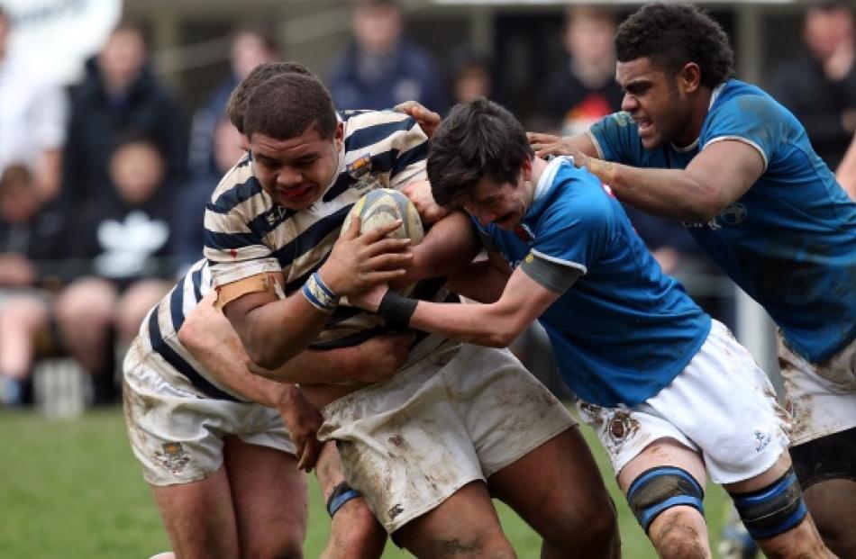 Sioni Asi of Otago Boys High School is hit hard by the Southland Boys High School defence during...