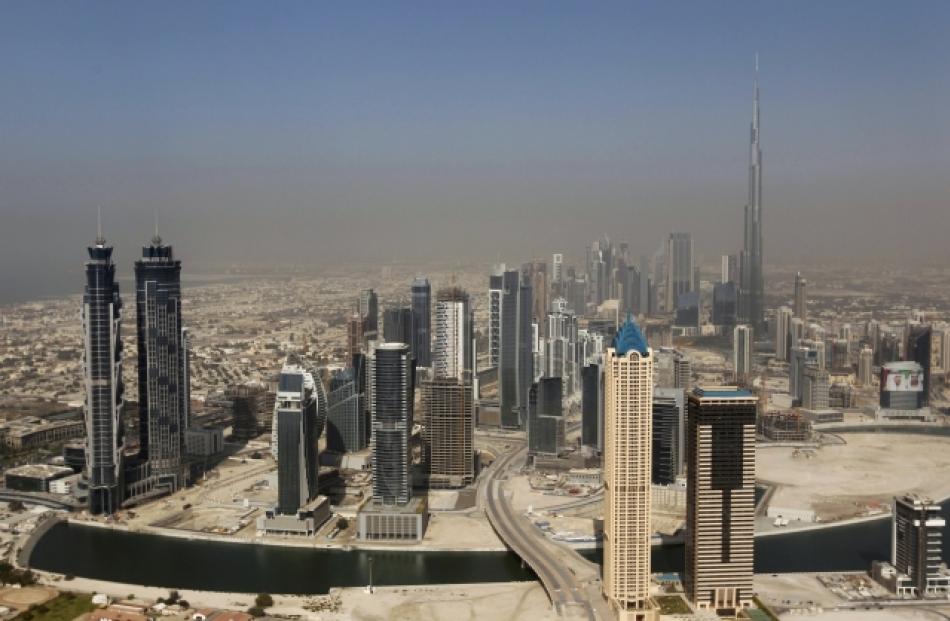 Skyscrapers are seen with the Burj Khalifa (at right), the tallest tower in the world at a height...