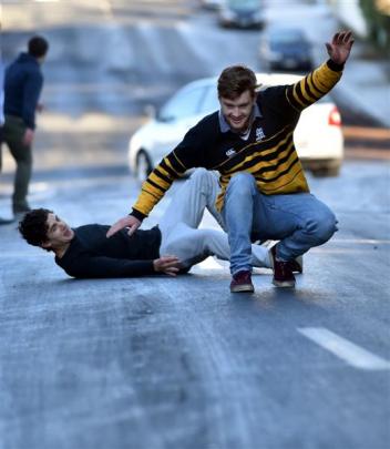 Sliding on ice on a North Dunedin road yesterday were students  James Logan (19, left) and James...