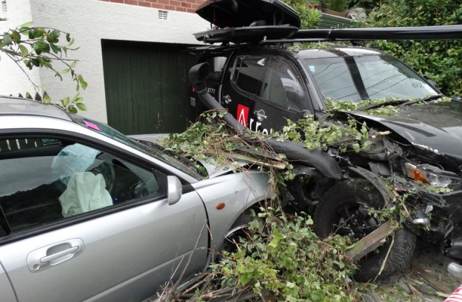 Smashed: The scene outside a Thompson St, Queenstown, property after a car (left) smashed through...