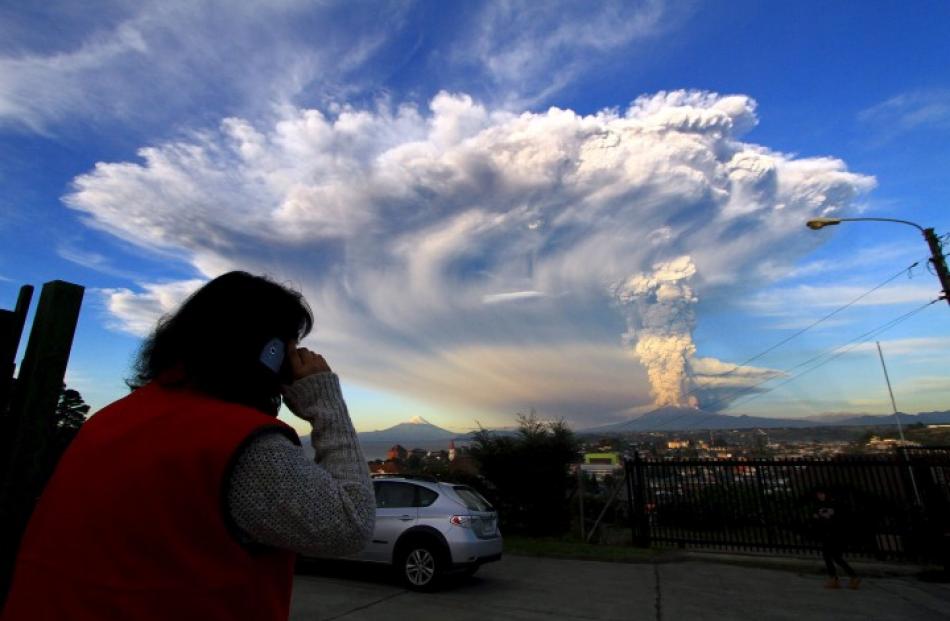 Smoke and ash rise from the volcano, the Calbuco volcano, as seen from Puerto Varas. REUTERS...