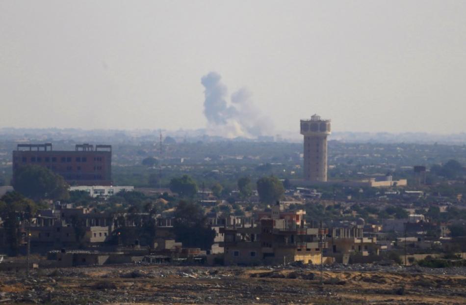 Smoke rises in Egypt's North Sinai as seen from the border of southern Gaza Strip with Egypt....