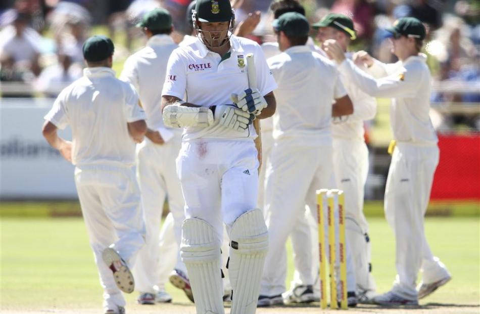 South Africa's Graeme Smith leaves the pitch as Australia celebrate his wicket. REUTERS/Shaun Roy...