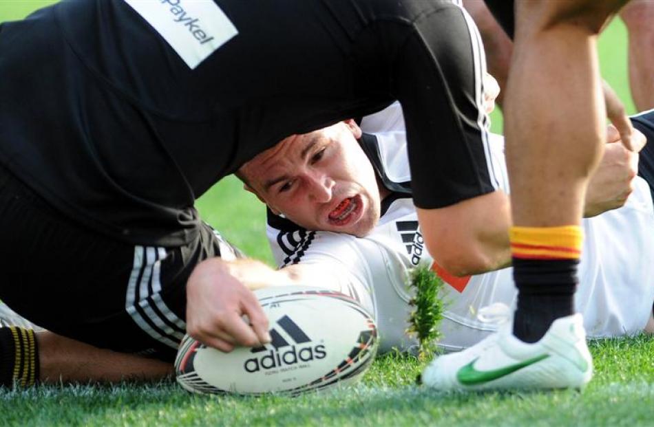 South Island first five-eighth Tom Marshall gets the ball over the line for a try. Photos by...