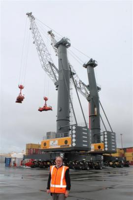 South Port port operations manager Geoff Finnerty is dwarfed by a new mobile container crane ...