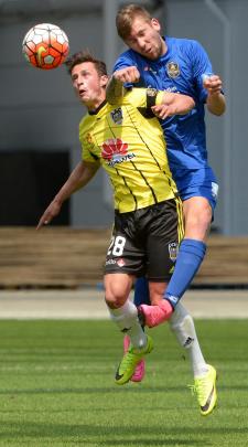 Southern United's Sam Redwood jumps above Joel Stevens, of the Wellington Phoenix, to head the...