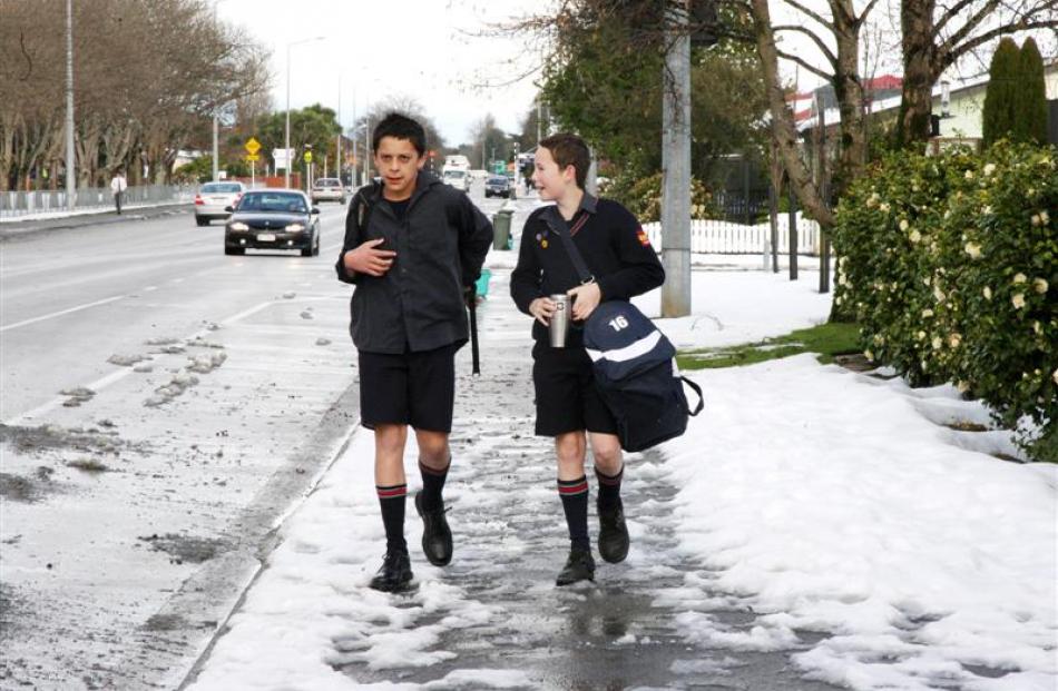 Southland Boys students walk to school after heavy snowfall closed many schools in Invercargill...