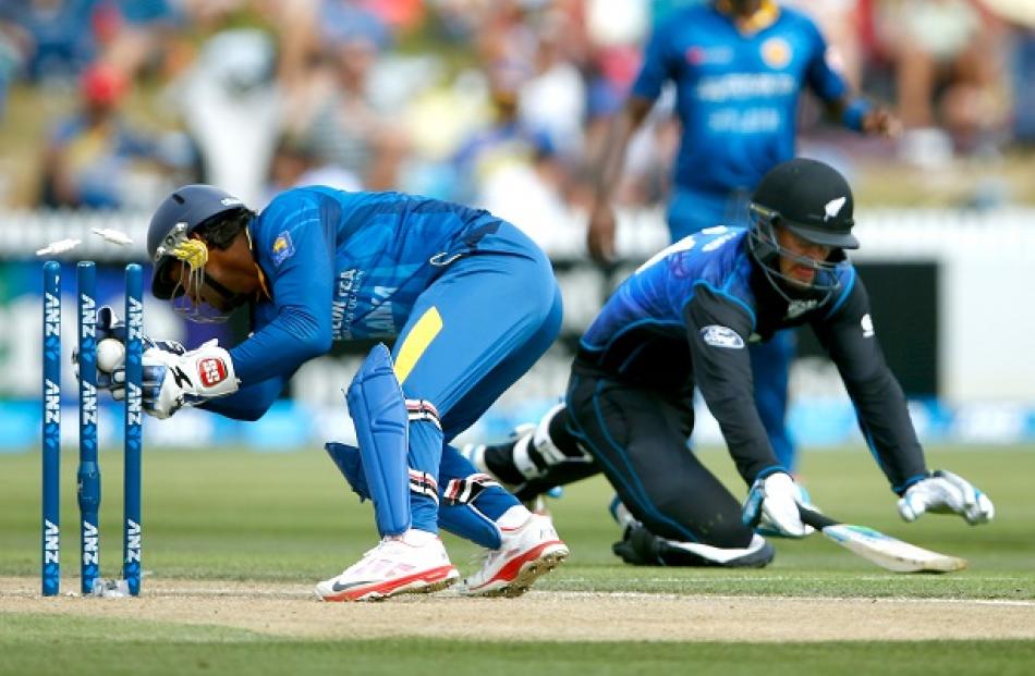 Sri Lanka's Kumar Sangakkara runs out New Zealand's Daniel Vettori during their ODI match in...