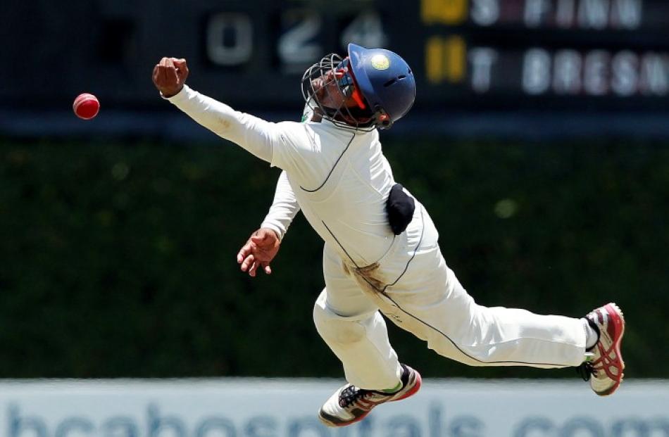 Sri Lanka's Lahiru Thirimanne tries to make a catch against England during the third day of the...