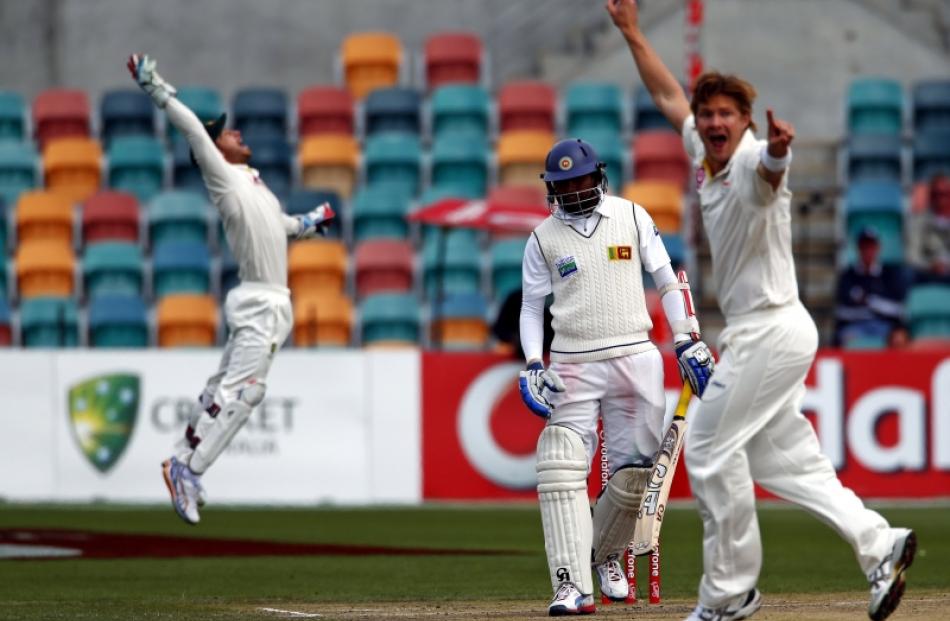 Sri Lanka's Tillakaratne Dilshan (centre) watches as Australia's Shane Watson (right) and...