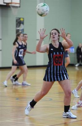 St Hilda's Collegiate goal defence Libby Jones offloads  the ball  in her side's game against...