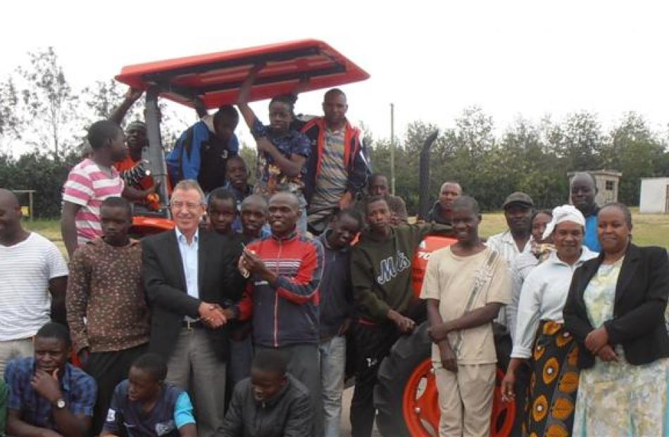 Staff and pupils at an agricultural training farm in Kenya with a new tractor, bought with New...