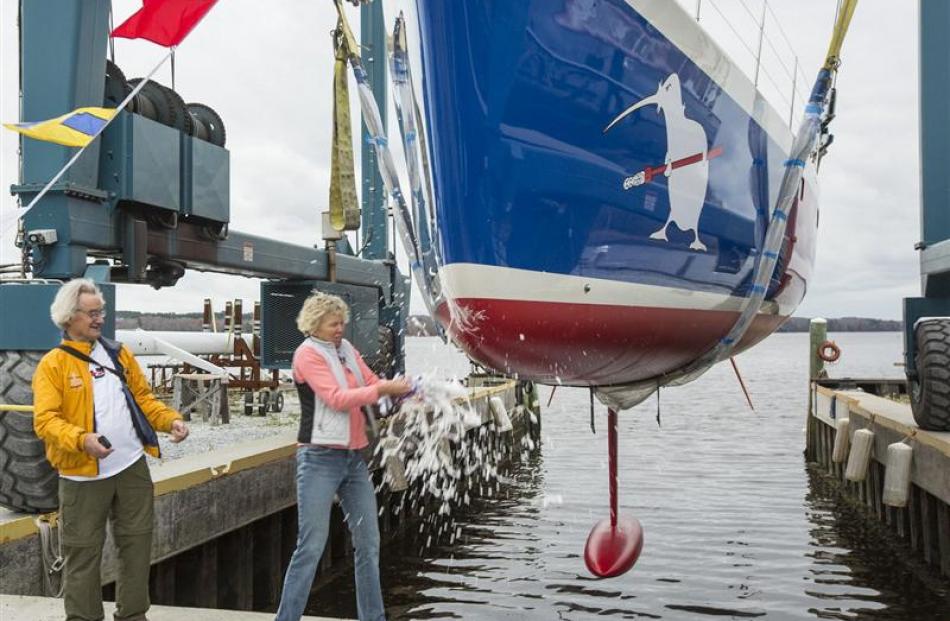 Stanley Paris  watches as  Heidi Lyman smashes a Champagne bottle over the bow of his yacht Kiwi...