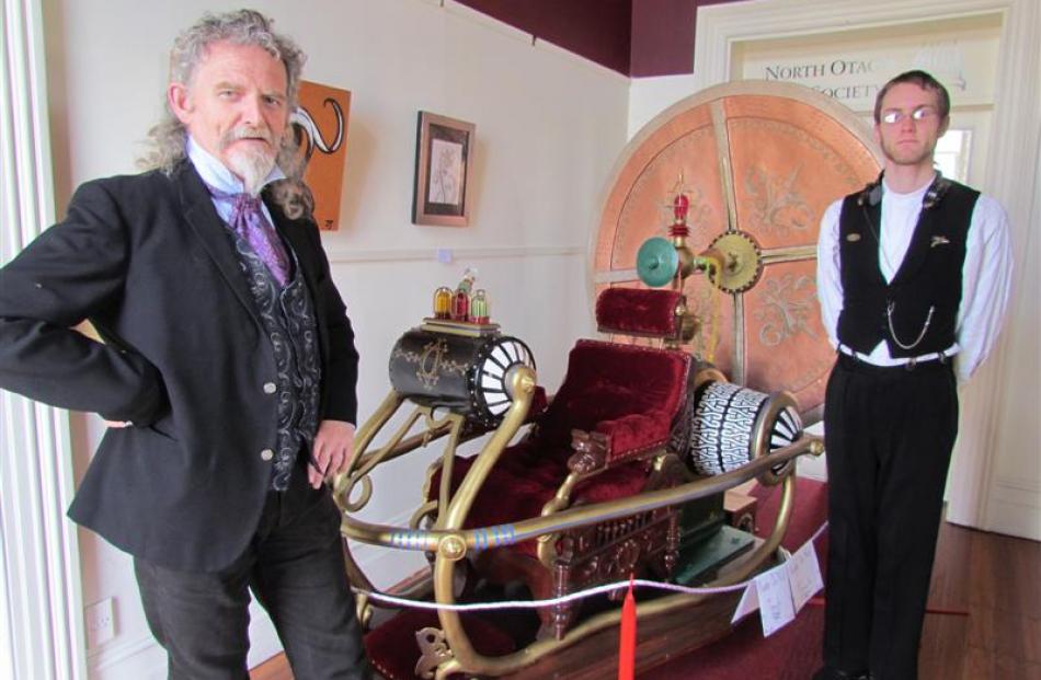 Steampunk art exhibition co-organiser Iain Clark, left, and Edward Allan with the replica of the...