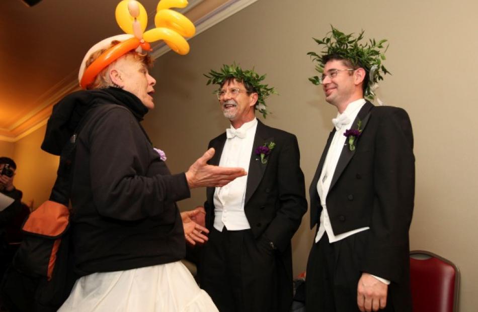 Steven Jones (C) and Jamous Lizzotte speak with Gabe Morte as they wait to receive marriage...