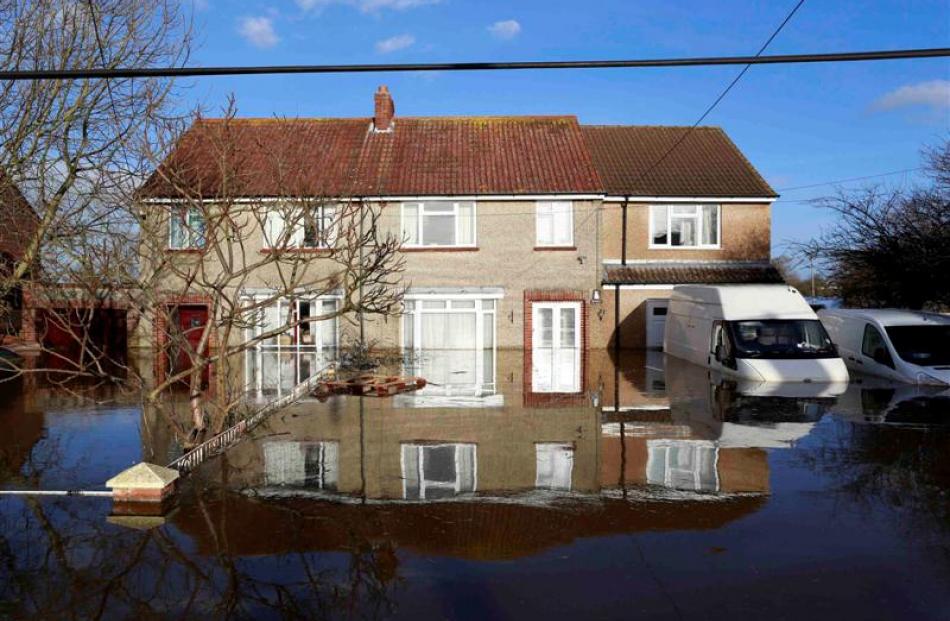 Stranded vehicles in the flooded Somerset village of Moorland last month. REUTERS/Cathal McNaughton