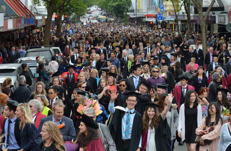 Students stream  down George St towards the Dunedin Town Hall during Saturday’s graduands  parade.