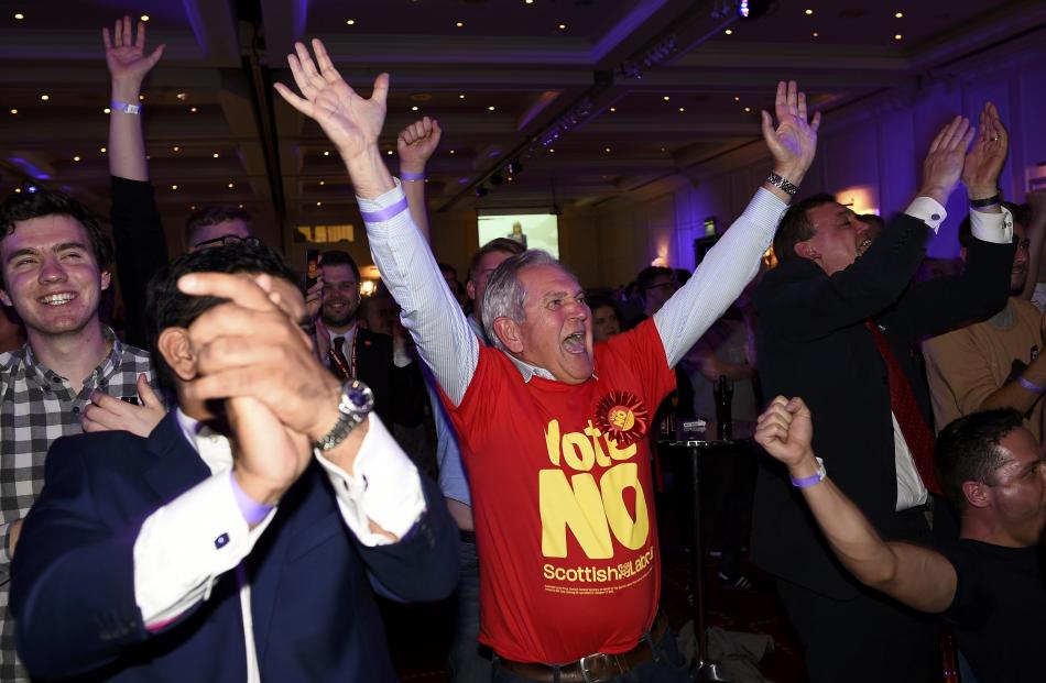 Supporters from the "No" Campaign react to a declaration in their favour, at the Better Together...