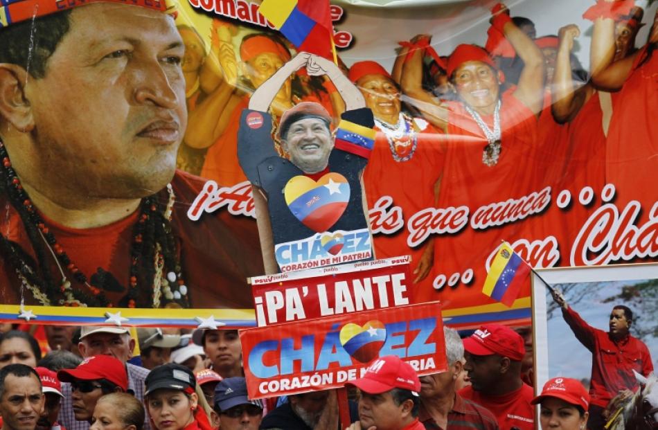 Supporters of Venezuelan President Hugo Chavez attend a rally outside Miraflores Palace in...