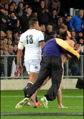 A streaker is tackled by security  worker Brad Hemopo at the All Blacks versus England test match...