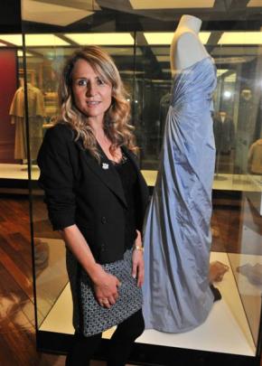 Tanya Carlson with the gown she designed, featured in a display at the Toitu Otago Settlers...