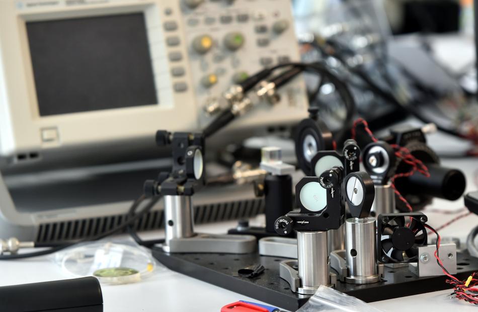 Testing mirror holders used in Phototonic's cutting-edge, laser-based technology.Photo: Peter...