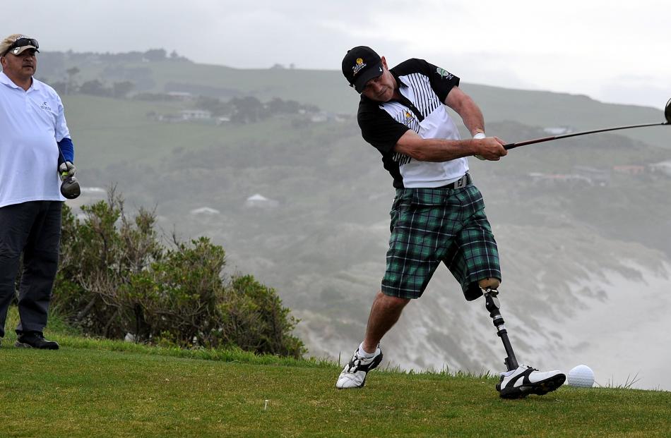 Tete Tahapeehi looks on as Jason Eade tees off on the ninth hole.