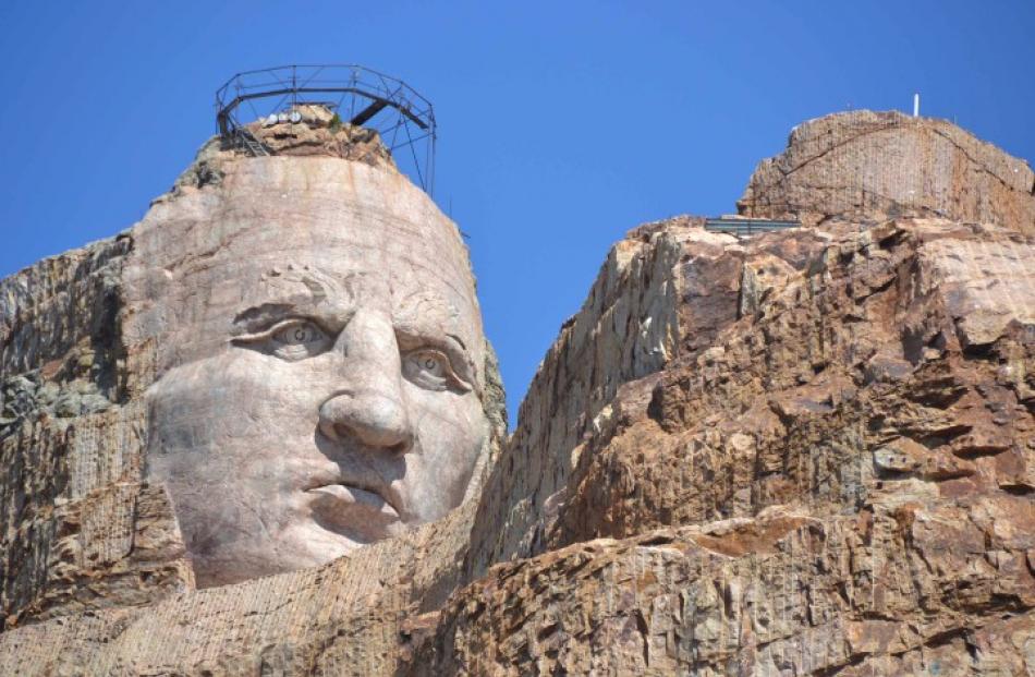 The carved granite face of Crazy Horse is seen in South Dakota's Black Hills in this photograph...
